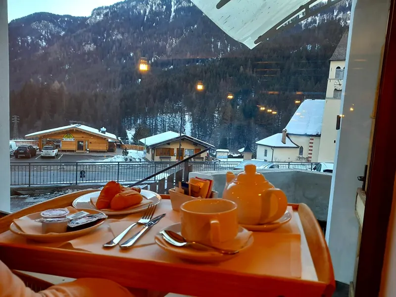 Breakfast served at the table with a view of the snow-covered village