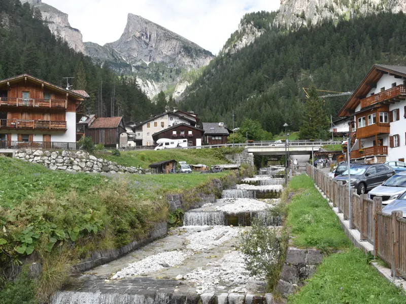 The stream running through Mazzin between the wooden houses