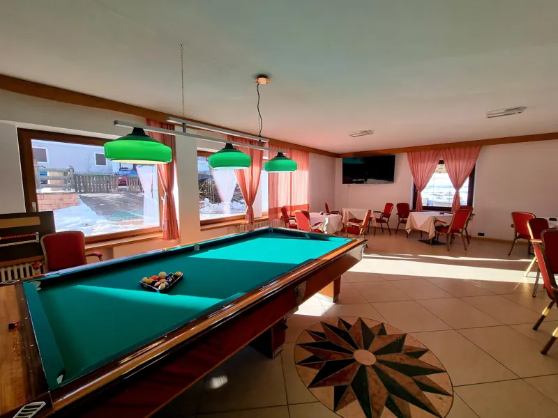 Common room with a billiard table and large windows