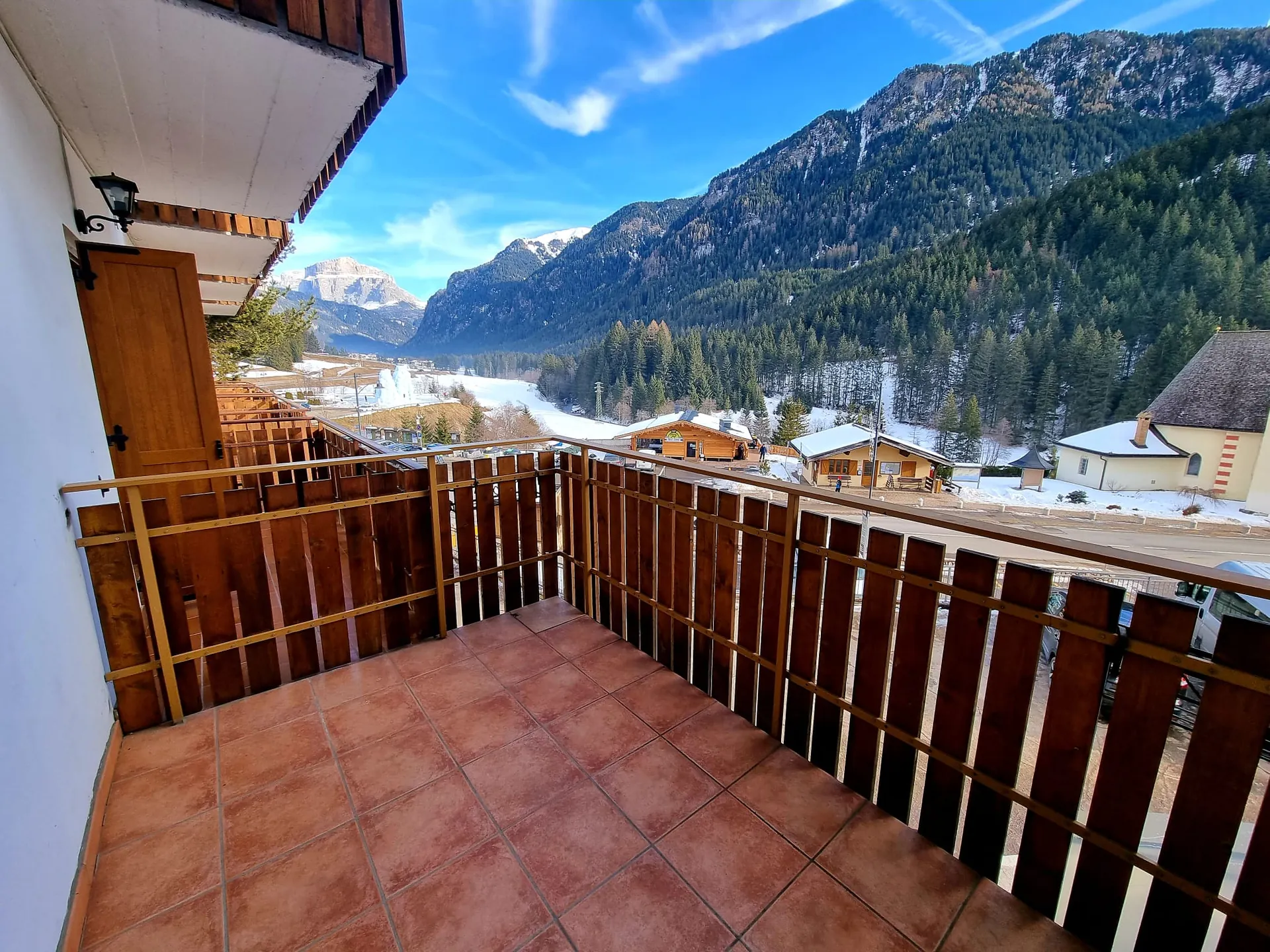 Wooden balcony of a room with a view over Val di Fassa