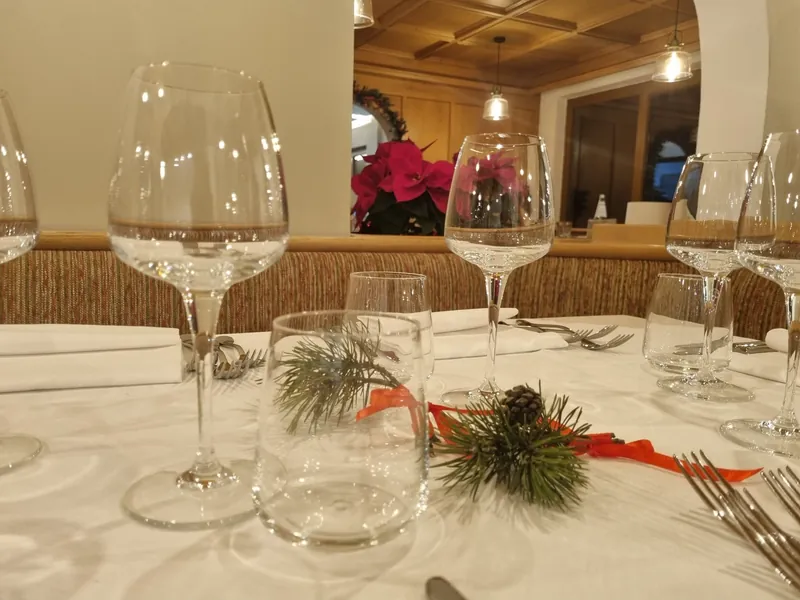 Laid table with wine glasses and a fir sprig