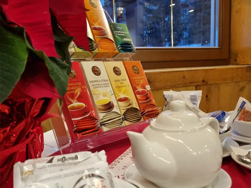 Teapot and a selection of teas on a table decorated for the holidays